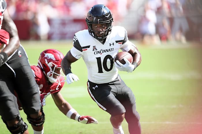 Sep 3, 2022; Fayetteville, Arkansas, USA; Cincinnati Bearcats running back Charles McClelland (10) rushes against the Arkansas Razorbacks during the second quarter at Donald W. Reynolds Razorback Stadium. Mandatory Credit: Nelson Chenault-USA TODAY Sports